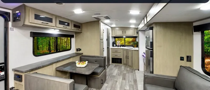 Inside a travel trailer: dinette, galley and cabinets