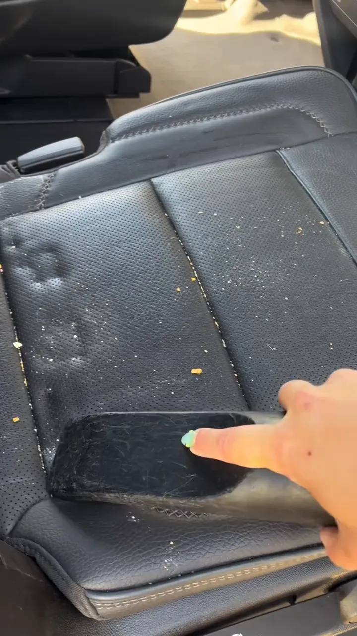 Crumbs and grime on a leather seat before the detail
