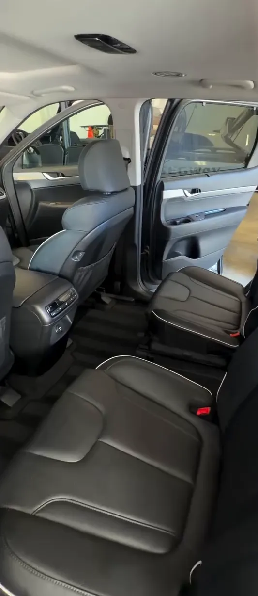 The back seats of a Hyundai Palisade after a Kay's interior detail: clean leather and striped carpets